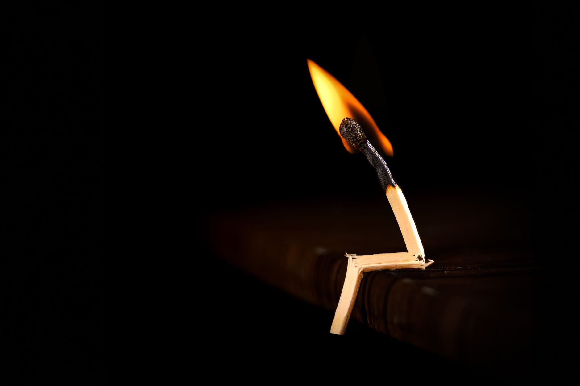 creative matchstick burning on a dark background